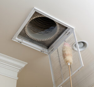 Dusting the vent before changing out the air filter in Pearland, TX home.